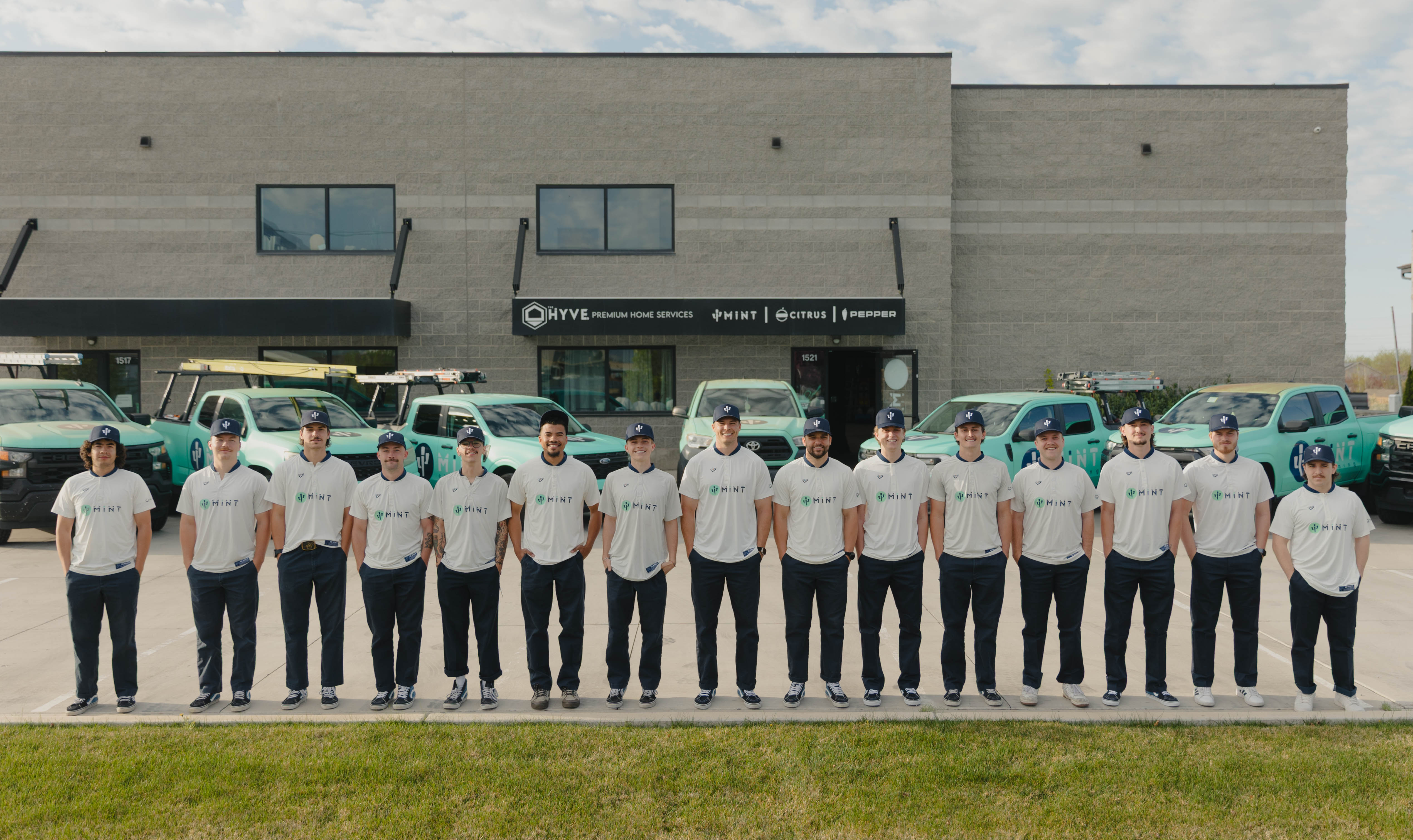 The MiNT team standing in front of their fleet of service vehicles